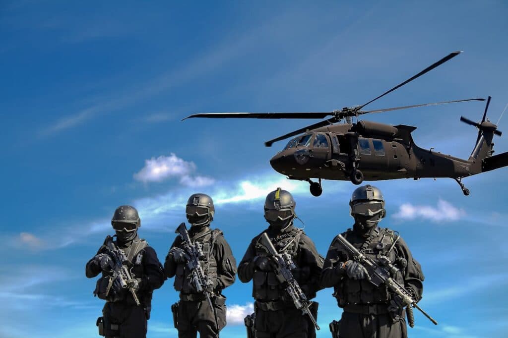Special forces soldiers in tactical gear with helicopter overhead